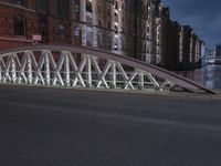 a pedestrian bridge over an empty street during night time, with no people in view