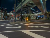 an image of outside of the night time building with the lights turned on and the streets empty