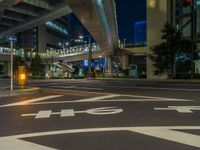 an image of outside of the night time building with the lights turned on and the streets empty