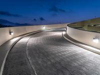 a view of a road and an overpass with traffic passing through it by buildings