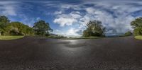 view of street through a circular fisheye lens camera while the sun shines down