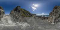 a split photo of a sandy, rocky mountain side road with some clouds in the sky and water