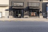 a view of a store across from a street with a bicycle and bike parked next to it