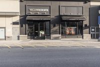 a view of a store across from a street with a bicycle and bike parked next to it