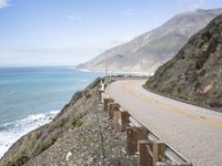 a beautiful view of the ocean from a highway side view looking down at the sea