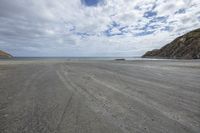 a person is riding his motorbike on the beach on a beautiful day with no clouds