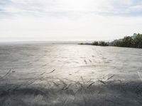 a view of some big rocks and water in the background with a sun on top