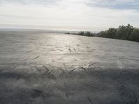 a view of some big rocks and water in the background with a sun on top