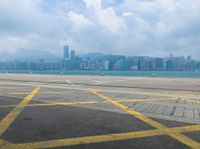 a big city and airport next to the water and land where two planes are landing