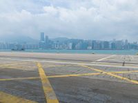 a big city and airport next to the water and land where two planes are landing