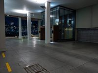 a empty commercial space is lit by lights from the city windows above the area at night