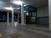 a empty commercial space is lit by lights from the city windows above the area at night