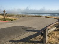 a quiet street by the ocean with no cars on it for a good view of the water