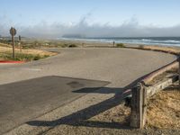 a quiet street by the ocean with no cars on it for a good view of the water