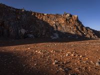 red rocks in an empty, barren landscape, under a clear blue sky, with no clouds