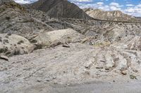 an image of the road is rocky and dirty and it looks rough and dusty and very rocky