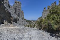 a hiker is seen walking down the trail at a gorge edge on a mountain