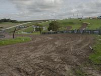 a dirt track with a rider coming towards the end end zone on top of it