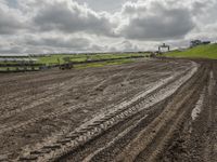 a dirt track with a rider coming towards the end end zone on top of it