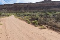 a dirt road winding in a valley with mountains in the background is an old style