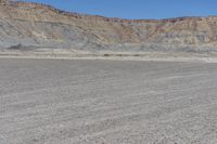 a red truck is driving through the rocky landscape of the desert of an arid area