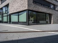 a brick building with many windows in front of it and some white lines on the outside of the building