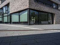 a brick building with many windows in front of it and some white lines on the outside of the building