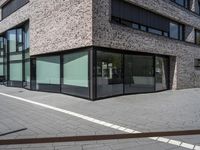 a brick building with many windows in front of it and some white lines on the outside of the building