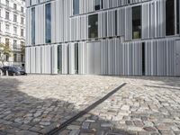 the modern building is made out of metal panels and bricks with a decorative, double - face window opening