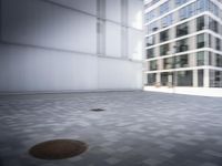 skateboarder performing an trick in a modern city setting with high buildings and cobblestone floor