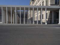 the building with pillars has a lot of columns on each side of it, all in two different directions