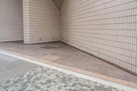 a white brick wall sitting behind a doorway to an entrance area at a school or business area