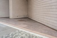 a white brick wall sitting behind a doorway to an entrance area at a school or business area