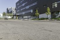 a fire hydrant is sitting in the middle of an empty street outside an office building