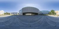 a photo taken with a fish eye lens at the intersection of a circular courtyard and an office building