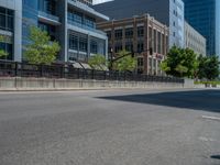 an empty street with buildings and parked cars on the sidewalks and green lanes on the sidewalk