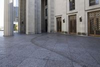 an open walkway in front of two buildings with windows and doors on one side of them