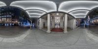 a very large fisheye mirror shows the entrance to an office building where it is built in the city