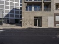 the wall of an apartment building that has writing on it's side of it