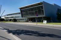 an empty street and an office building in the distance on a clear day in europe