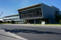 an empty street and an office building in the distance on a clear day in europe