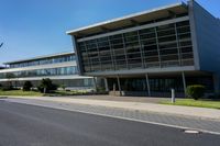 an empty street and an office building in the distance on a clear day in europe