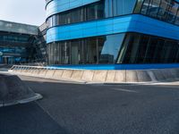 a large blue building with many windows on the side of it's glass sides