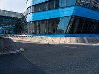 a large blue building with many windows on the side of it's glass sides