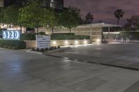 a view of an office building at night from a parking lot looking outside at it