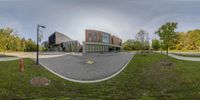 a 360 - view image of an office building in the middle of a park on a sunny day