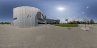 this is an image of a building with a parking lot in front of it on a sunny day