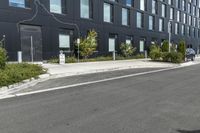 a black building on the corner with a painted line across the side and trees by the side