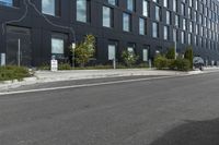 a black building on the corner with a painted line across the side and trees by the side