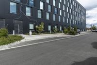 a black building on the corner with a painted line across the side and trees by the side